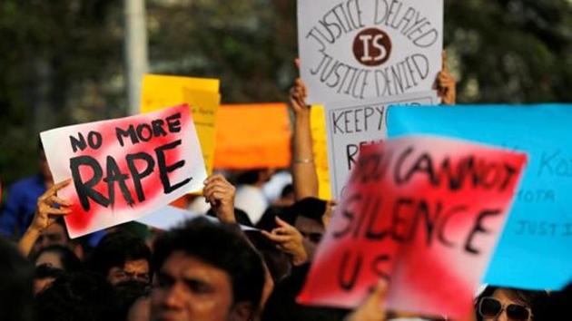 File photo of people holding placards as they participate in a protest against rapes, in Mumbai.(REUTERS)