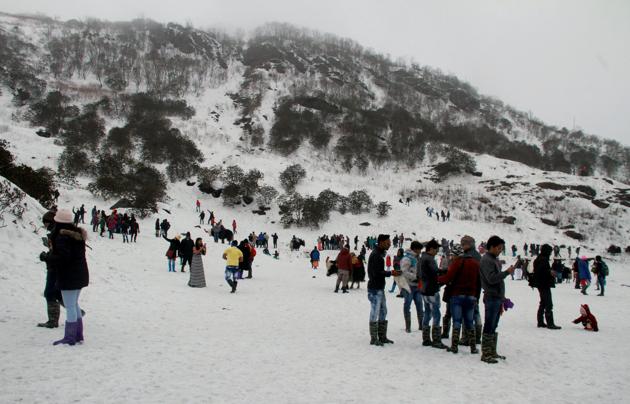 Tourists enjoy the view of snow covered hills around the Changu Lake after fresh snowfall, some 40 kilometres from Gangtok, in Sikkim.(PTI File Photo)