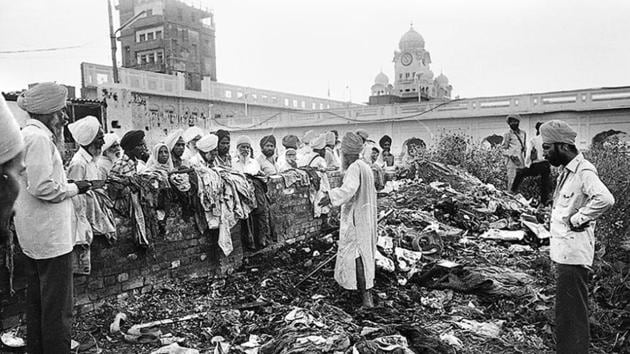 Devotees look at the damage inflicted on the Golden Temple in Amritsar after the Operation Bluestar in 1984. (HT File) Devotees look at the damage inflicted on the Golden Temple in Amritsar after the Operation Bluestar in 1984. (HT File)