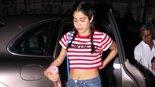 Janhvi Kapoor looks every bit a star here in a pair of torn jeans and red-and-white crop top. (Viral Bhayani) Janhvi Kapoor looks every bit a star here in a pair of torn jeans and red-and-white crop top. (Viral Bhayani)