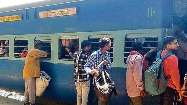 Disregarding the ‘women-only’ sign, male passengers queue up to board a compartment of the Malwa express at the Ludhiana railway station on Sunday. (Gurpreet Singh/HT) Disregarding the ‘women-only’ sign, male passengers queue up to board a compartment of the Malwa express at the Ludhiana railway station on Sunday. (Gurpreet Singh/HT)