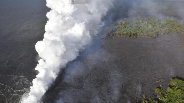 Lava from fissure 20 is seen entering the ocean near Pahoa, Hawaii on Sunday. The interaction of lava and seawater has created a cloud of steam laced with hydrochloric acid and fine glass particles that can irritate the skin and eyes and cause breathing problems. (US Geological Survey / AP) Lava from fissure 20 is seen entering the ocean near Pahoa, Hawaii on Sunday. The interaction of lava and seawater has created a cloud of steam laced with hydrochloric acid and fine glass particles that can irritate the skin and eyes and cause breathing problems. (US Geological Survey / AP)