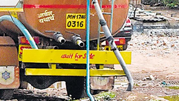 Water tanker illegally fills water from a punctured PMC water tank at Wadgaonsheri.(Sanket Wankhade/HT PHOTO)