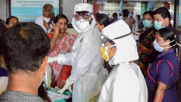 Family members of the patients admitted at the Kozhikode Medical College wear safety masks after the 'Nipah' virus outbreak, in Kozhikode.(PTI Photo)