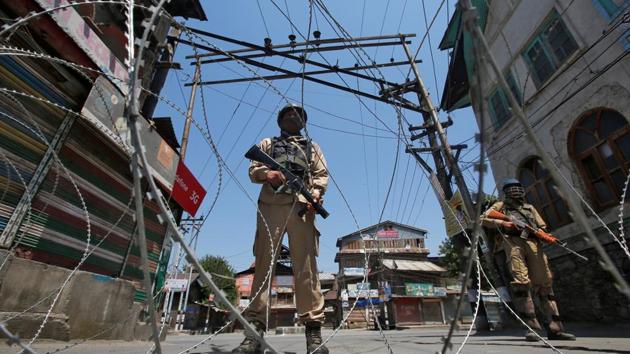 Policemen stand guard behind concertina wire during a strike called by separatists to mark the death anniversaries of Mirwaiz Mohammad Farooq and Abdul Gani Lone in Srinagar on May 21. (REUTERS) Policemen stand guard behind concertina wire during a strike called by separatists to mark the death anniversaries of Mirwaiz Mohammad Farooq and Abdul Gani Lone in Srinagar on May 21. (REUTERS)