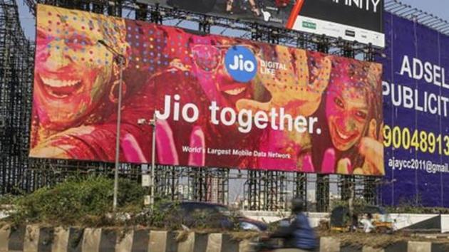 Traffic travels past a billboard for Reliance Jio Infocomm Ltd. in the Bandra area of Mumbai, India.(Bloomberg via Getty Images)