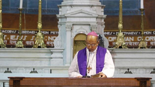 Archbishop of Delhi, Anil Couto, reads from a holy book during a service on Good Friday at the Sacred Heart Cathedral in New Delhi.(AP File Photo)
