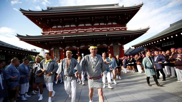 People make their way to carry a mikoshi, at the Senso-ji Temple. The festival is held in celebration of the three founders of the temple, who are enshrined next door in Asakusa Shrine. Nearly two million people visit Asakusa over the festival, making it one of Tokyo’s most popular. (Kim Kyung-Hoon / REUTERS) People make their way to carry a mikoshi, at the Senso-ji Temple. The festival is held in celebration of the three founders of the temple, who are enshrined next door in Asakusa Shrine. Nearly two million people visit Asakusa over the festival, making it one of Tokyo’s most popular. (Kim Kyung-Hoon / REUTERS)