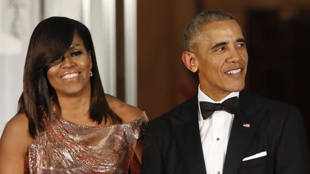 Netflix says that it has reached a deal with Barack and Michelle Obama to produce material for the streaming service.(AP)