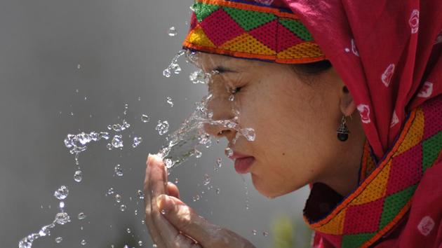 A woman splashes water on her face as she tries to get some relief from scorching heat, in Chandigarh on Tuesday. (Karun Sharma/HT)