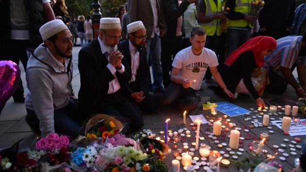 People pray and light candles set up in front of floral tributes in Albert Square in Manchester, northwest England on May 23, 2017, in solidarity with those killed and injured in the May 22 terror attack at the Ariana Grande concert at the Manchester Arena.(AFP File Photo) People pray and light candles set up in front of floral tributes in Albert Square in Manchester, northwest England on May 23, 2017, in solidarity with those killed and injured in the May 22 terror attack at the Ariana Grande concert at the Manchester Arena.(AFP File Photo)