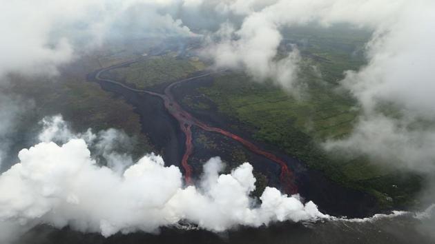 Steam plumes rise as lava enters the Pacific Ocean after flowing to the water from a Kilauea volcano fissure, on Hawaii's Big Island on May 21, 2018 near Pahoa, Hawaii. ‘Laze’ -- a word combination of lava and haze -- is a dangerous product produced when hot lava hits cool ocean water.(AFP)