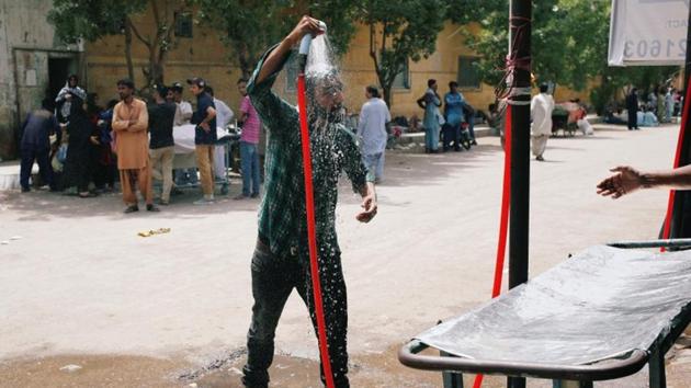 A man cools off with a shower, setup at the premises of the Dr Ruth KM Pfau Civil Hospital, during a heatwave in Karachi, Pakistan on May 20, 2018.(REUTERS) A man cools off with a shower, setup at the premises of the Dr Ruth KM Pfau Civil Hospital, during a heatwave in Karachi, Pakistan on May 20, 2018.(REUTERS)