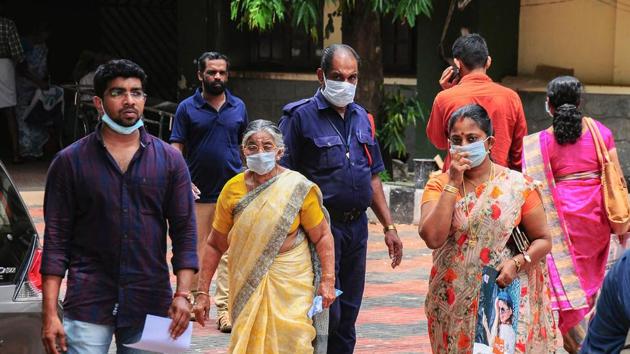 Hospital staff and family members of the patients admitted at the Kozhikode Medical College wear safety masks as a precautionary measure after the Nipah virus outbreak.(PTI Photo)