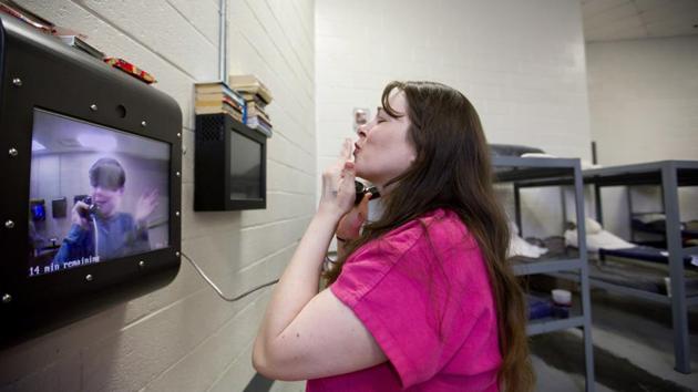 Inmate Krystle Sweat blows a kiss to her son Robby, 10, during a video conference as he visits her at the jail. There are no face-to-face visits other than exceptional circumstances. Robby hasn’t hugged or even touched his mother since Christmas Day 2015, just before Sweat wound up back behind bars. In 2015, Campbell County had the third-highest amount of opioids prescribed per person in the nation. (David Goldman / AP)