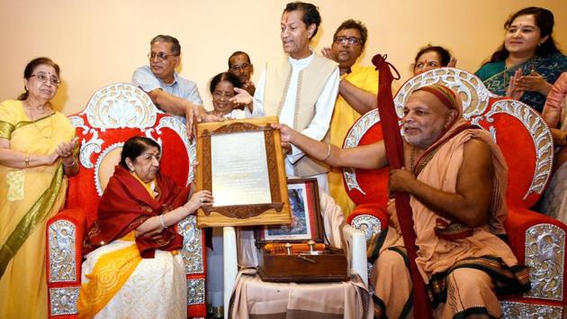Jagadguru Shankaracharya of Karveer Mutt Kolhapur bestows the title of Swara Mauli upon Lata Mangeshkar at her residence in Mumbai. (PTI) Jagadguru Shankaracharya of Karveer Mutt Kolhapur bestows the title of Swara Mauli upon Lata Mangeshkar at her residence in Mumbai. (PTI)