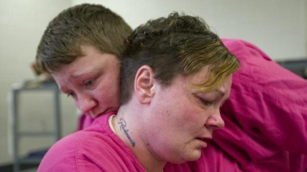 Mary Sammons, 41, foreground, is comforted by cellmate Blanche Ball, 30, days after Sammons learned that her 20-year-old son was murdered in Kentucky. Sammons, who was arrested on drug-related charges, suspects her son’s murder was drug-related. “I always pictured my kids burying me, not me having to bury my children. Young kids are losing their life over bad dope.” (David Goldman / AP)