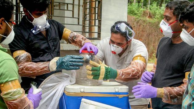 Animal Husbandry department and forest officials collect bats from a well of a house after the outbreak of 'Nipah' virus, near Perambra in Kozhikode on Monday. (PTI) Animal Husbandry department and forest officials collect bats from a well of a house after the outbreak of 'Nipah' virus, near Perambra in Kozhikode on Monday. (PTI)