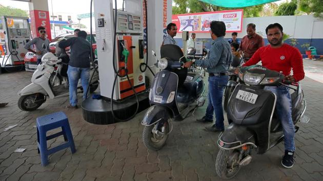 People get their two-wheelers filled with petrol at a fuel station in Ahmedabad, India.(REUTERS File Photo)