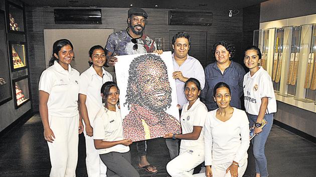 Chris Gayle with Pune’s women cricketers at the Blades of Glory museum at Sahakarnagar in Pune on Tuesday.(HT PHOTO)