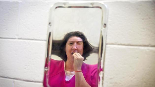Samantha Marlow brushes her teeth in a distorted metal mirror in her cell. Some women are in for theft; others for drug possession. There’s no treatment available in the jail, no counselling or chance to work, no other courses other than a high school equivalency diploma program. Lt. Mallory Campbell, assistant jail administrator, would like to offer more, but there isn’t money for programs or staff. (David Goldman / AP)