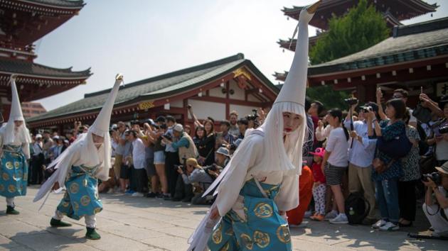 Participants in swan costumes perform a dance during the first day of the festival on May 18. The day is filled with official parades, music and food stalls along Asakusa’s streets. There are dances and Shinto prayers for a good harvest and prosperity. (Carl Court / Getty Images) Participants in swan costumes perform a dance during the first day of the festival on May 18. The day is filled with official parades, music and food stalls along Asakusa’s streets. There are dances and Shinto prayers for a good harvest and prosperity. (Carl Court / Getty Images)