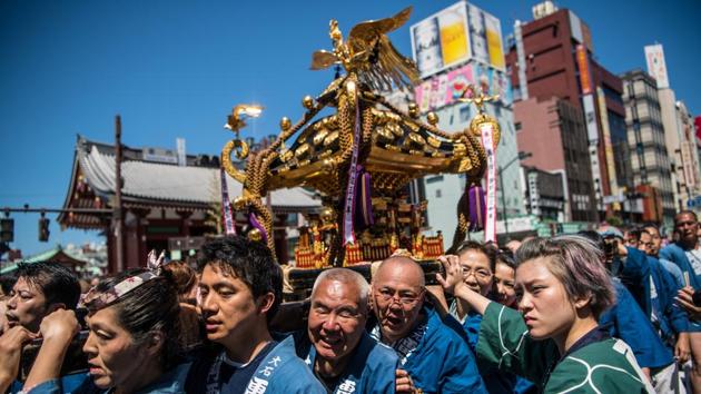 Once the main mikoshi have been blessed at the temple they are also paraded through town, vigorously jostled on the men’s shoulders to intensify the power of the deities placed inside and after a couple of hours they’re placed back at the shrine, until next year. (Carl Court / Getty Images) Once the main mikoshi have been blessed at the temple they are also paraded through town, vigorously jostled on the men’s shoulders to intensify the power of the deities placed inside and after a couple of hours they’re placed back at the shrine, until next year. (Carl Court / Getty Images)