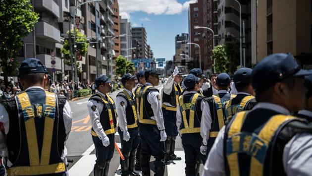 Police officers attempt to control the procession during the third and final day. Despite their presence, there is no confrontation between police and the Yakuza during the festival. (Carl Court / Getty Images) Police officers attempt to control the procession during the third and final day. Despite their presence, there is no confrontation between police and the Yakuza during the festival. (Carl Court / Getty Images)