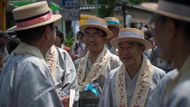 The streets fill up with participants in period costumes, many dressed in traditional Edo era styles. Participants dress in costumes that match their roles in the parade, as officials, musicians or dancers. (Carl Court / Getty Images) The streets fill up with participants in period costumes, many dressed in traditional Edo era styles. Participants dress in costumes that match their roles in the parade, as officials, musicians or dancers. (Carl Court / Getty Images)