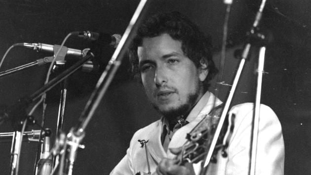 Bob Dylan in concert at the Isle of Wight Pop Festival, 1969 after rejecting Woodstock. As the decade moved into the 1970s Dylan’s motorcycle crash, a shift towards Judeo Christian symbolism, and a change in his sound from the mood of the 1960 shaped his reclusion. A return to touring after seven years in 1974 preceded his Evangelical Christian period, marked by declarations of faith onstage and refusals to play older, secular songs. (William Lovelace / Express / Getty Images)