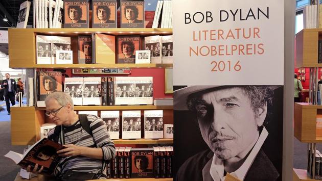 A man reads a book about Bob Dylan at the 2016 Frankfurt Book Fair. In 2016, Bob Dylan became the first musician to win the Nobel Prize in Literature “for having created new poetic expressions within the great American song tradition”. After two weeks of silence on his award, Dylan spoke at an interview, calling it “amazing, incredible. Whoever dreams about something like that?” (annelore Foerster / Getty Images)