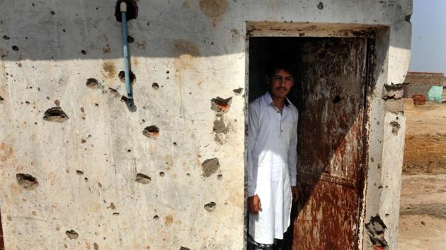A villager inspects the damage after his home was gutted by Pakistan firing in Jora village in RS Pura district of Jammu on Tuesday. (Nitin Kanotra /HT Photo)