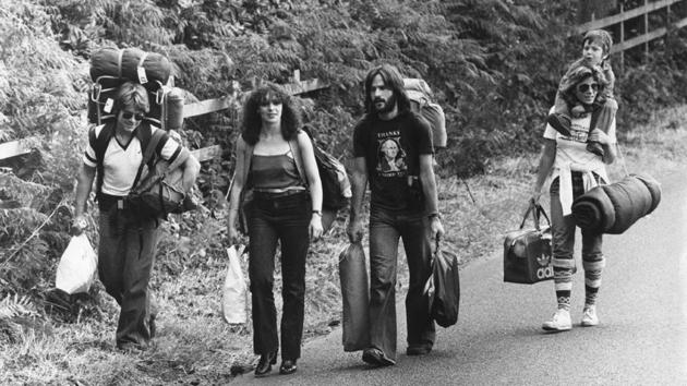 Hippies on their way to Picnic at Blackbushe in Hampshire for a Bob Dylan concert on July 14, 1978. By the mid-60s Dylan had changed what a pop song could convey with politicized albums like The Times They Are a-Changin’ and songs such as ‘Like a Rolling Stone’. A prolific but varied output had audiences and critics divided on his music but agreed on his stature as a leading songwriter. (Colin Davey / Evening Standard / Getty Images)