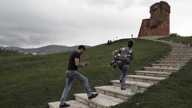People visit the monument “We Are Our Mountains”' in Stepanakert. But the region has “learned to coexist with the conflict,” said the separatists’ foreign affairs minister, Masis Mayilian. “We have created the institutions both to maintain our existence and for our development.” (Thanassis Stavrakis / AP) People visit the monument “We Are Our Mountains”' in Stepanakert. But the region has “learned to coexist with the conflict,” said the separatists’ foreign affairs minister, Masis Mayilian. “We have created the institutions both to maintain our existence and for our development.” (Thanassis Stavrakis / AP)