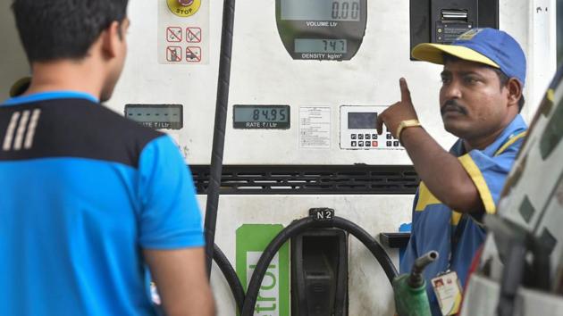 A petrol pump employee serves a customer at a fuel station, as fuel prices reached the highest-ever, in Mumbai on Thursday.(PTI Photo)