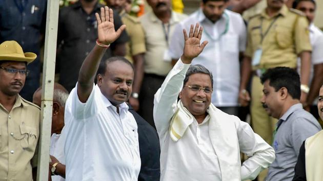 Karnataka chief minister H D Kumaraswamy with former chief minister and Congress leader Siddaramaiah during the swearing-in ceremony of JD(S)-Congress coalition government, in Bengaluru, on May 23.(PTI Photo)