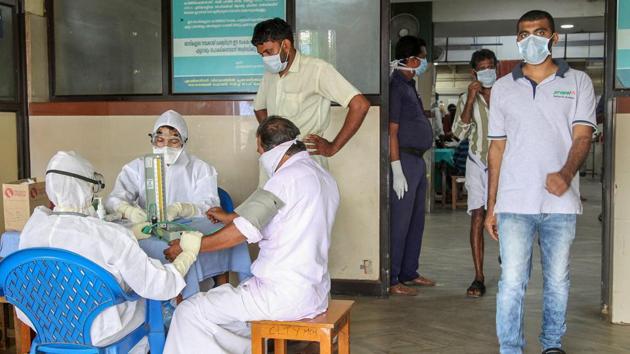 Doctors and patients wear safety masks as a precautionary measure after the 'Nipah' virus outbreak, at a Medical college, in Kozhikode, on Wednesday. (PTI Photo) Doctors and patients wear safety masks as a precautionary measure after the 'Nipah' virus outbreak, at a Medical college, in Kozhikode, on Wednesday. (PTI Photo)