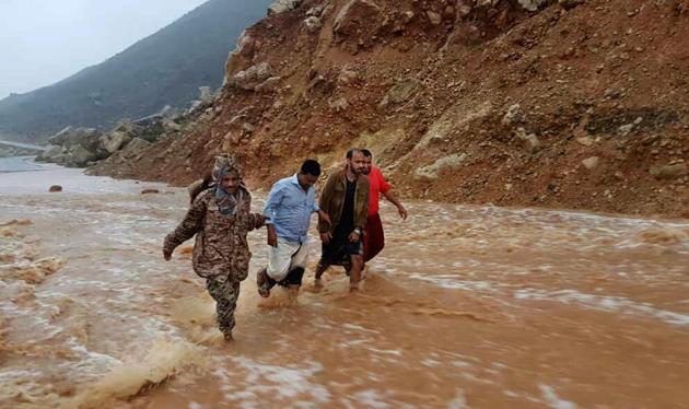 Men walk on a road flooded after heavy rain and strong winds in Hadibu as Cyclone Mekunu pounded the Yemeni island of Socotra, on Thursday.(AP)