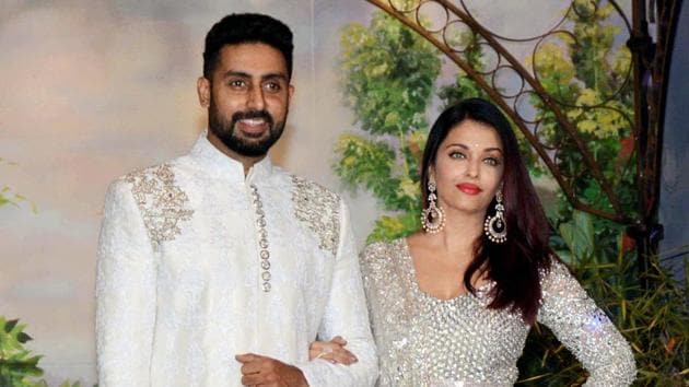 Abhishek Bachchan and wife Aishwarya Rai Bachchan pose for a picture during the wedding reception of Sonam Kapoor.(PTI)
