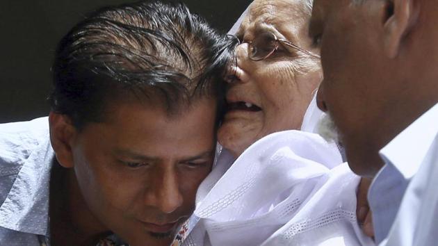 Abdul Aziz Sheikh (L), father of Sabika Sheikh, a victim of a shooting at a Texas high school, comforts an elderly woman at a condolence ceremony for his daughter at his home in Karachi, Pakistan. (Fareed Khan / AP)