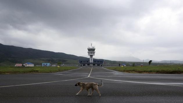 A dog walks on the empty runway of Stepanakert airport. It also has an international airport, built in 2011, but the one thing missing are the planes. Azerbaijan has warned it can’t guarantee the safety of flights to Nagorno-Karabakh. So, neatly stacked luggage trolleys, check-in desks and an air traffic control tower remain unused. (Thanassis Stavrakis / AP) A dog walks on the empty runway of Stepanakert airport. It also has an international airport, built in 2011, but the one thing missing are the planes. Azerbaijan has warned it can’t guarantee the safety of flights to Nagorno-Karabakh. So, neatly stacked luggage trolleys, check-in desks and an air traffic control tower remain unused. (Thanassis Stavrakis / AP)
