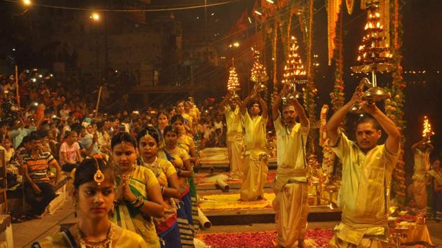 Priests perform aarti as women devotees pray during Ganga Dussehra festival at Dashashwamedh Ghat on the banks of the River Ganges in Varanasi, Uttar Pradesh on May 24, 2018. (Rajesh Kumar / HT Photo)