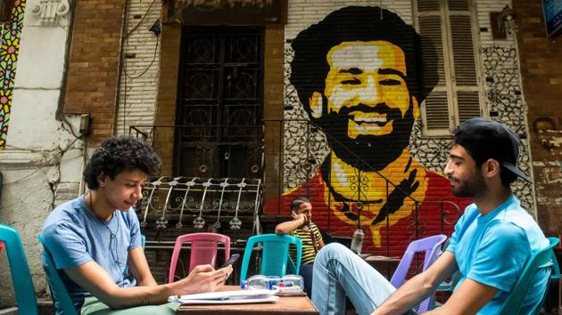 Men at a cafe in Cairo, with a mural behind them of Mohamed Salah. “The goals he scores ease the burden of living under these tough economic conditions,” said Maher Said, a 50-year-old security guard in Cairo. “Watching him play helps me get over tough days.” Another Egyptian, 30-year-old engineer Shereef Suliman, said: “Salah has virtually become the only thing that gives people hope and pride that they are Egyptians.” (Khaled Desouki / AFP)
