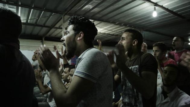 Men watch a Liverpool vs. Roma match at a cafe in Nagrig. Many Egyptians and commentators believe Salah is giving his compatriots hope and joy at a time when the majority is struggling to make ends meet amid acute economic hardships caused by an ambitious economic reform program to revive the battered economy. (Nariman El-Mofty / AP)