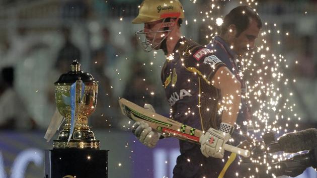 Kolkata Knight Riders' Chris Lynn enters the field walking past the IPL trophy on display during the VIVO IPL cricket T20 match against Rajasthan Royals in Kolkata, West Bengal on May 23, 2018. (Bikas Das / AP)