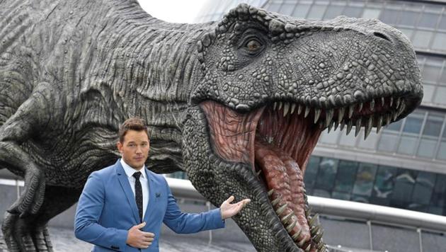 Chris Pratt poses in front of a model dinosaur during a photocall to promote the forthcoming film Jurassic World: Fallen Kingdom in London.(REUTERS)