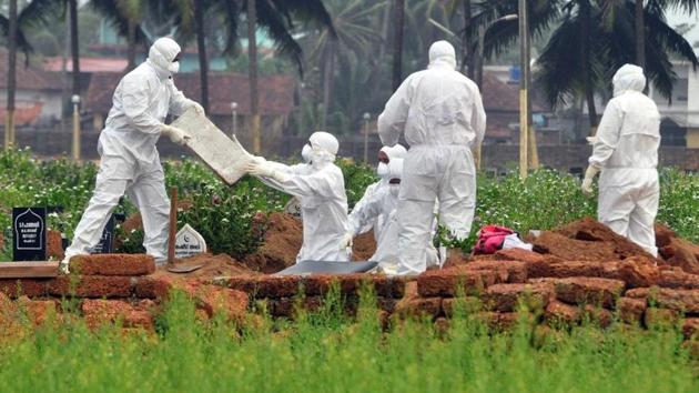 Doctors and relatives wearing protective gear dig a grave to bury the body of a victim who died due to Nipah virus at a burial ground in Kozhikode. The Kerala government on Friday asked Dr Kafeel Khan, the suspended paediatrician of the BRD Medical College in Uttar Pradesh’s Gorakhpur, to defer his plan to visit the areas affected by the deadly Nipah virus in the state. (REUTERS) Doctors and relatives wearing protective gear dig a grave to bury the body of a victim who died due to Nipah virus at a burial ground in Kozhikode. The Kerala government on Friday asked Dr Kafeel Khan, the suspended paediatrician of the BRD Medical College in Uttar Pradesh’s Gorakhpur, to defer his plan to visit the areas affected by the deadly Nipah virus in the state. (REUTERS)