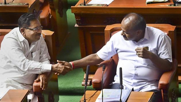 Karnataka Chief Minister H D Kumaraswamy and his deputy G Parameshwara greet each other after their coalition government won the trust vote by voice vote, at Vidhana Soudha in Bengaluru, on Friday. (PTI Photo) Karnataka Chief Minister H D Kumaraswamy and his deputy G Parameshwara greet each other after their coalition government won the trust vote by voice vote, at Vidhana Soudha in Bengaluru, on Friday. (PTI Photo)