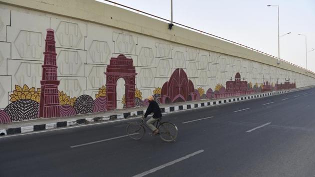 A cyclist is seen along the flyover near Commonwealth Sports Village on NH-24 which has been decorated with murals of Delhi’s famous tourist destinations like Red Fort, Humayun’s Tomb, Qutub Minar, India Gate and Lotus Temple. (Sanchit Khanna / HT Photo) A cyclist is seen along the flyover near Commonwealth Sports Village on NH-24 which has been decorated with murals of Delhi’s famous tourist destinations like Red Fort, Humayun’s Tomb, Qutub Minar, India Gate and Lotus Temple. (Sanchit Khanna / HT Photo)