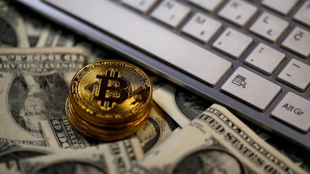 Bitcoin coins placed on Dollar banknotes, next to computer keyboard, are seen in this illustration picture.(REUTERS File Photo)